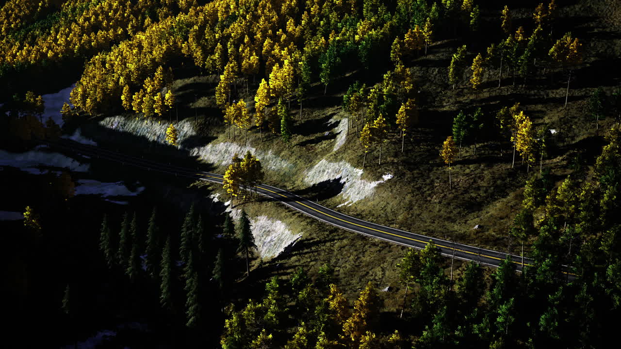 Winding road through vibrant autumn foliage in a mountainous area