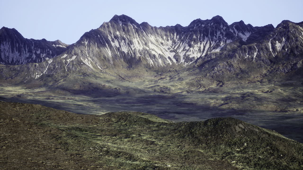 Majestic snow capped mountains rise above a serene valley landscape