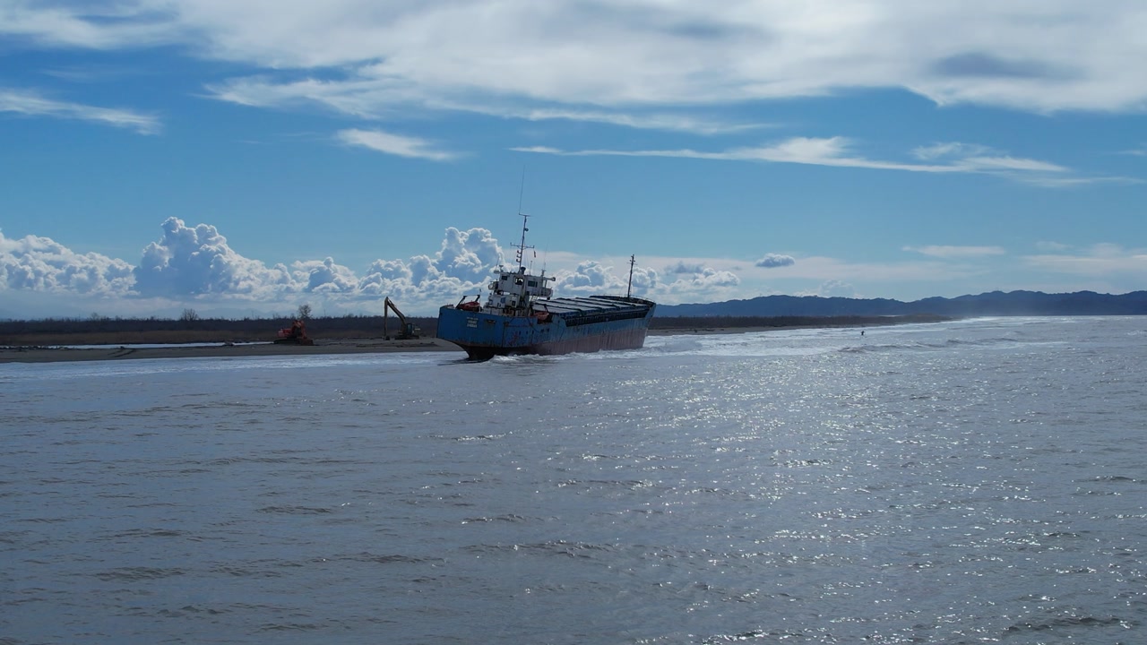 Stranded Container Vessel on Sandy Shoreline Metaphor for Global Trade Halt and Industrial Resource Scarcity