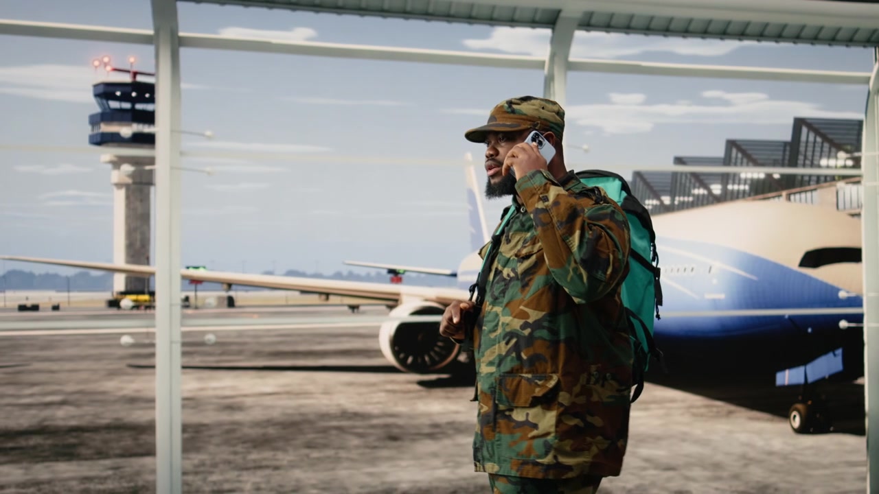 Soldato dell'esercito che telefona in aeroporto, preparandosi per il rientro a casa.