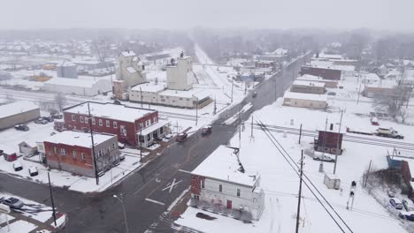 old grain elevator and train station in small town of michigan, winter season, aerial view