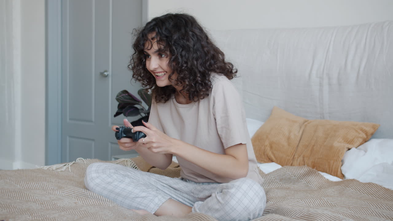 Woman Playing Video Games in Bed