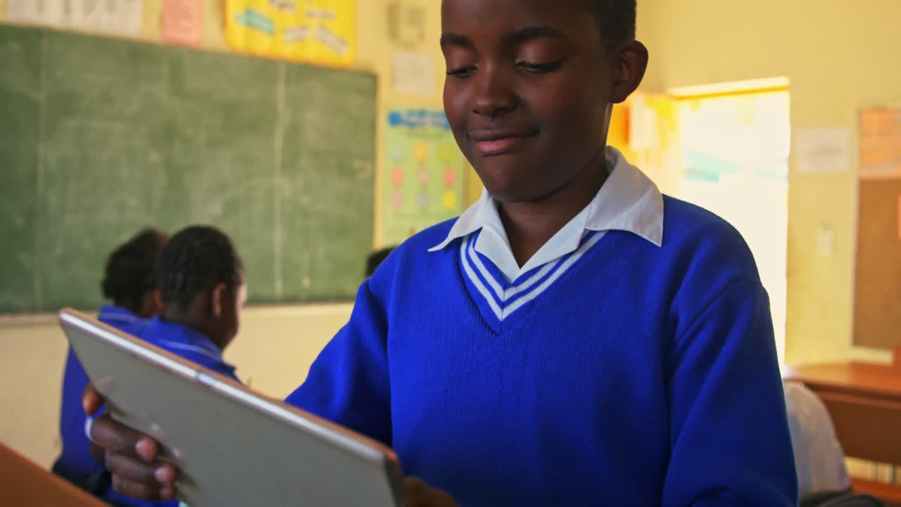 Schoolboy using tablet in a lesson at a township school 4k