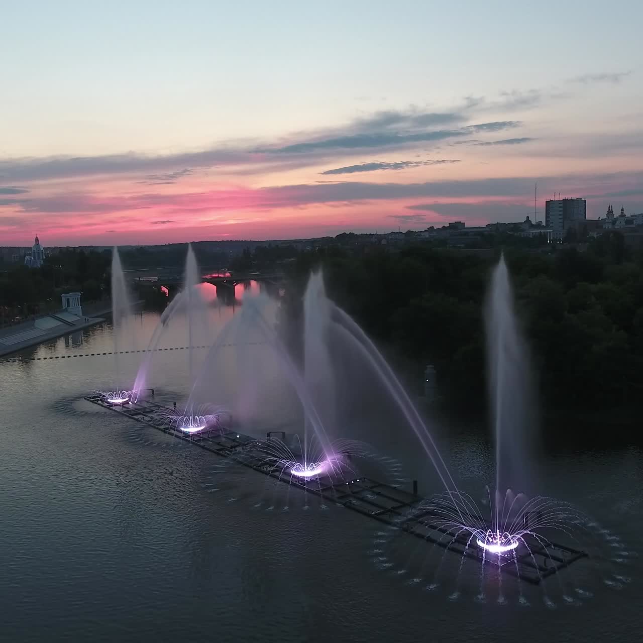 Music Fountain On The River. Aerial shot of the beautiful night performance of colorful fountains