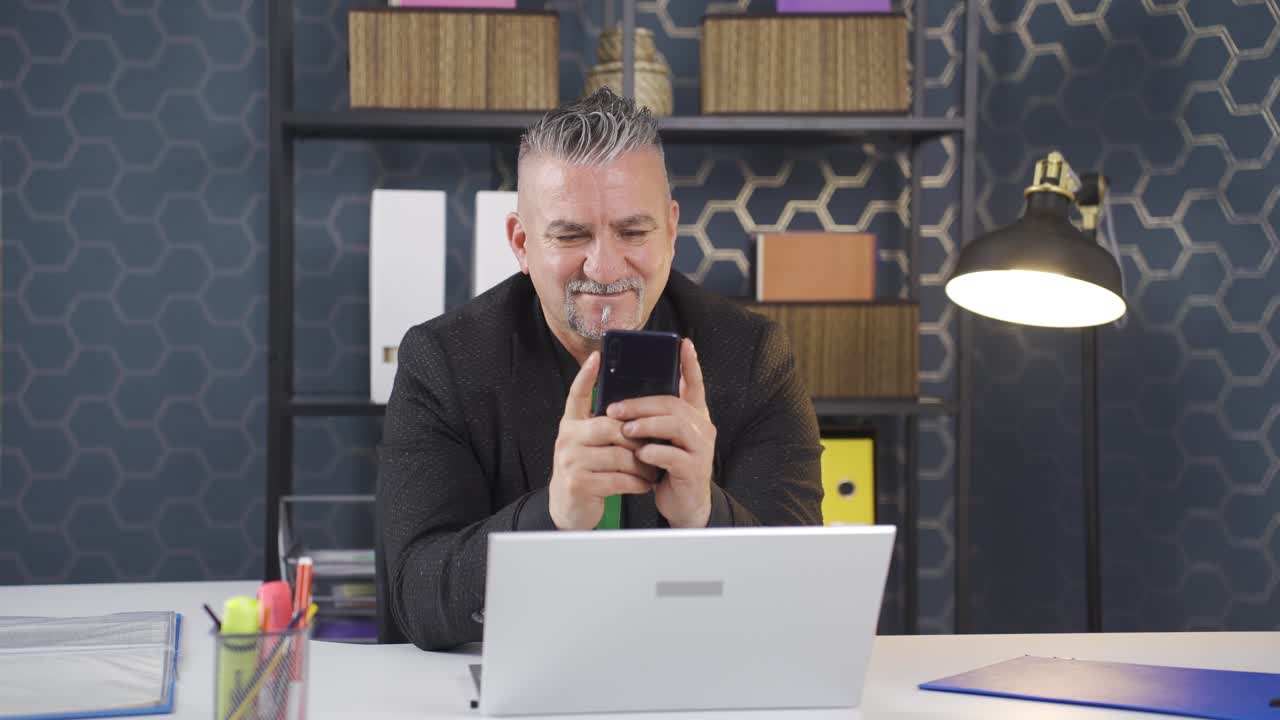 사업가가 전화로 문자 메시지를 보내고 있습니다.