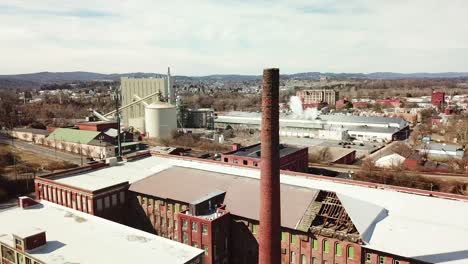 aerial over an abandoned american factory with smokestack near reading pennsylvania 3