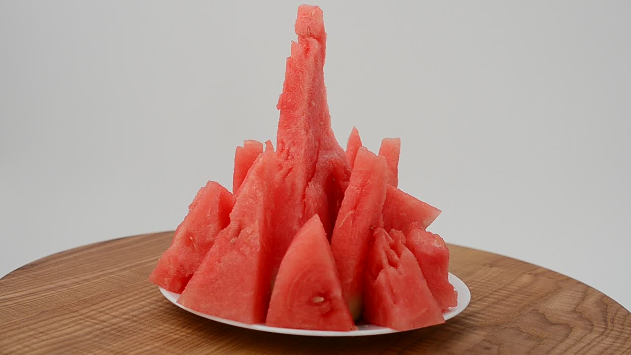 Shooting of a watermelon on a kitchen board. Shooting in the movement
