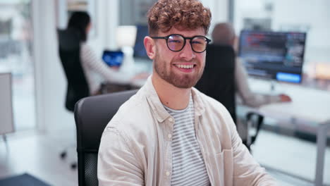 man with glasses and curly hair in office