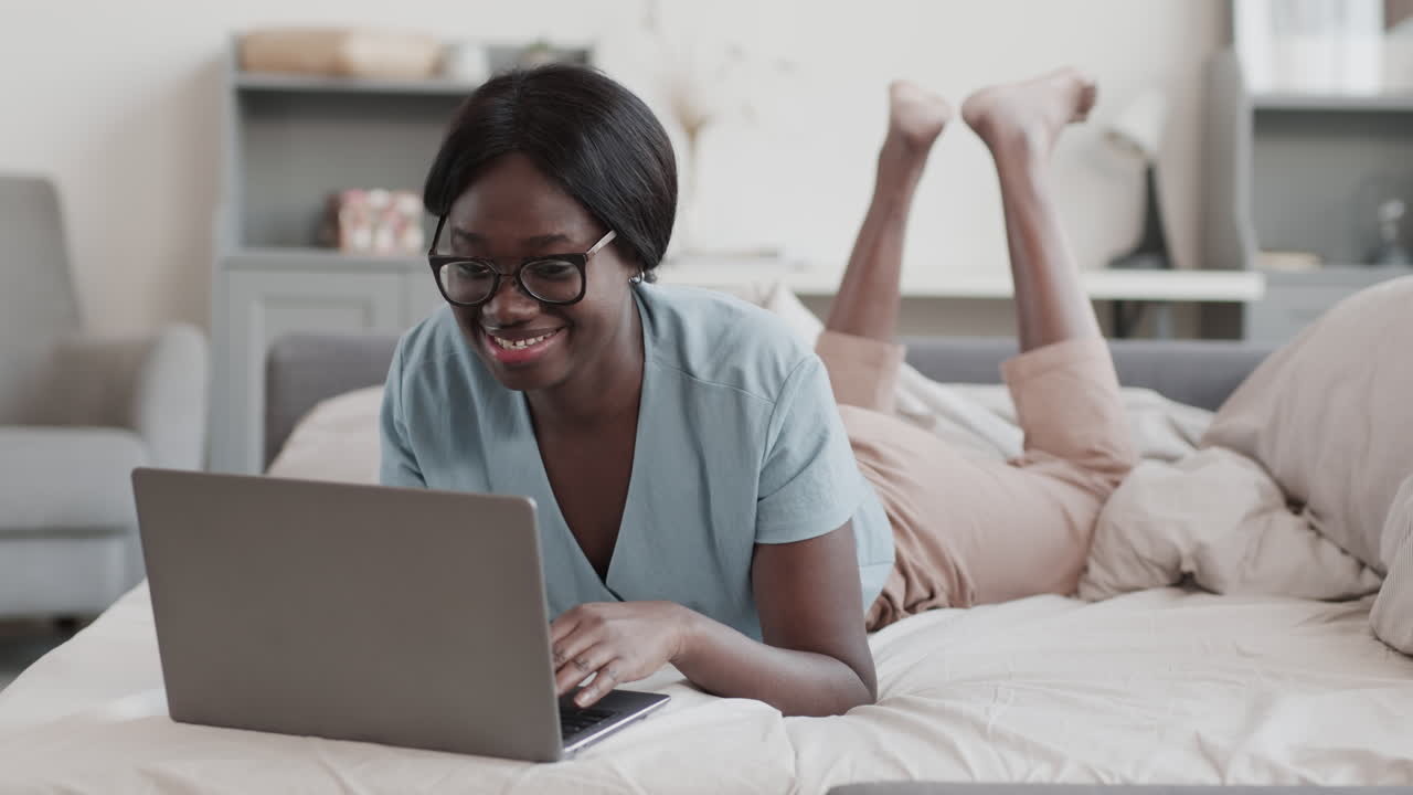 Cheerful African-American Woman Using Laptop