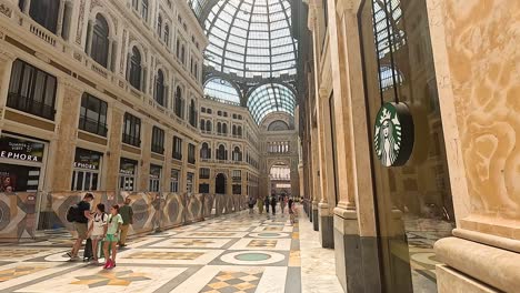 people walking inside galleria umberto, naples, italy