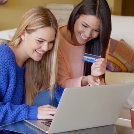 two young students sharing a laptop