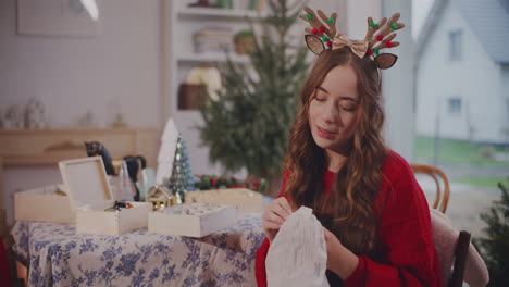 Woman-cleaning-bauble-with-cloth-at-home