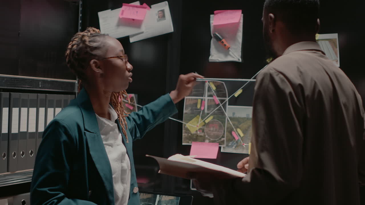 Detectives Collaborating on Crime Investigation in Office