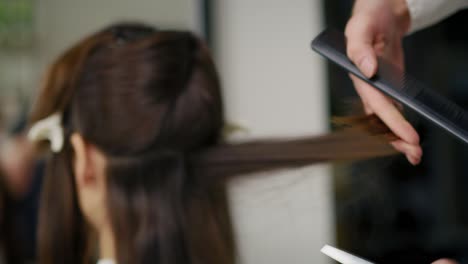 handheld video shows of long hair cut by hairdresser