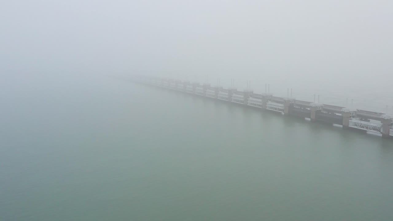 The storm surge barrier during thick fog, aerial shot