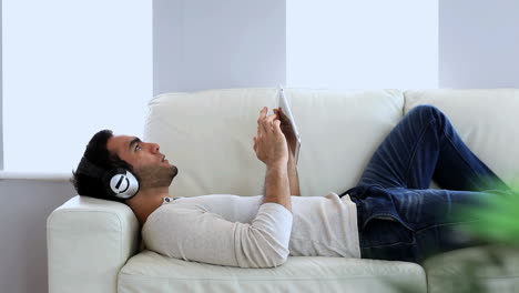 man listening to music with his tablet pc