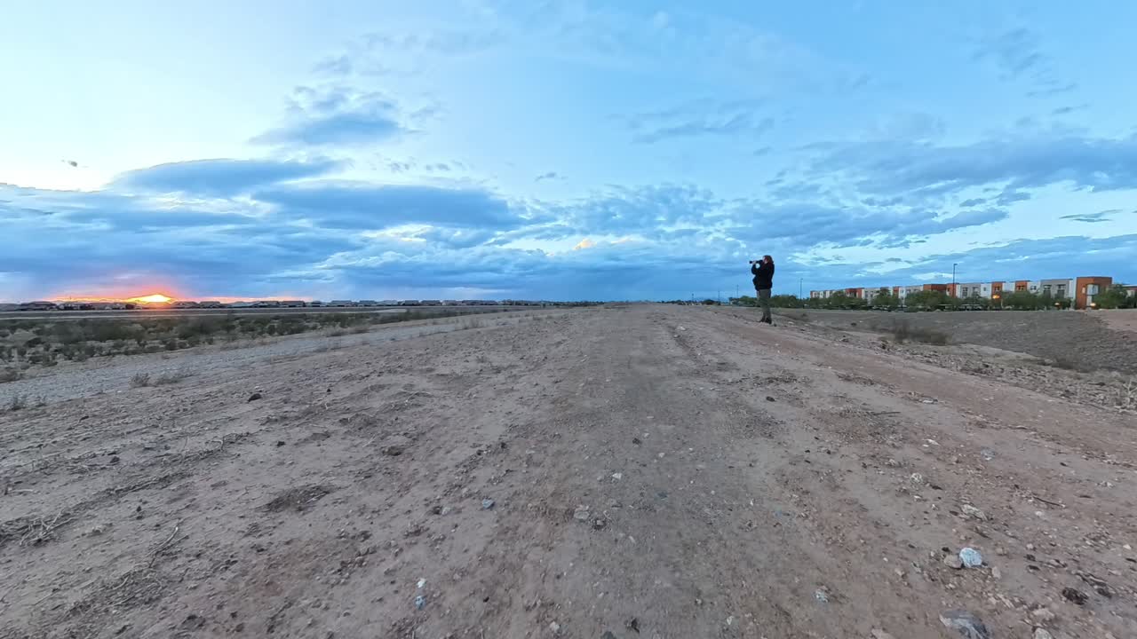 Photographer in Storm Clouds time lapse at sunset in Gilbert Arizona.