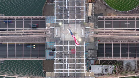 a top down view directly over the brooklyn bridge east tower at sunrise