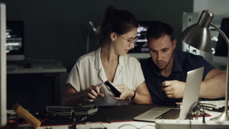 two-young-technicians-repairing-computer-hardware