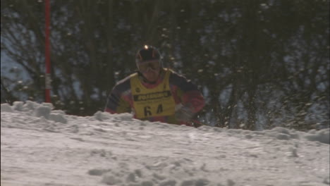 a skier races swiftly down a slalom course