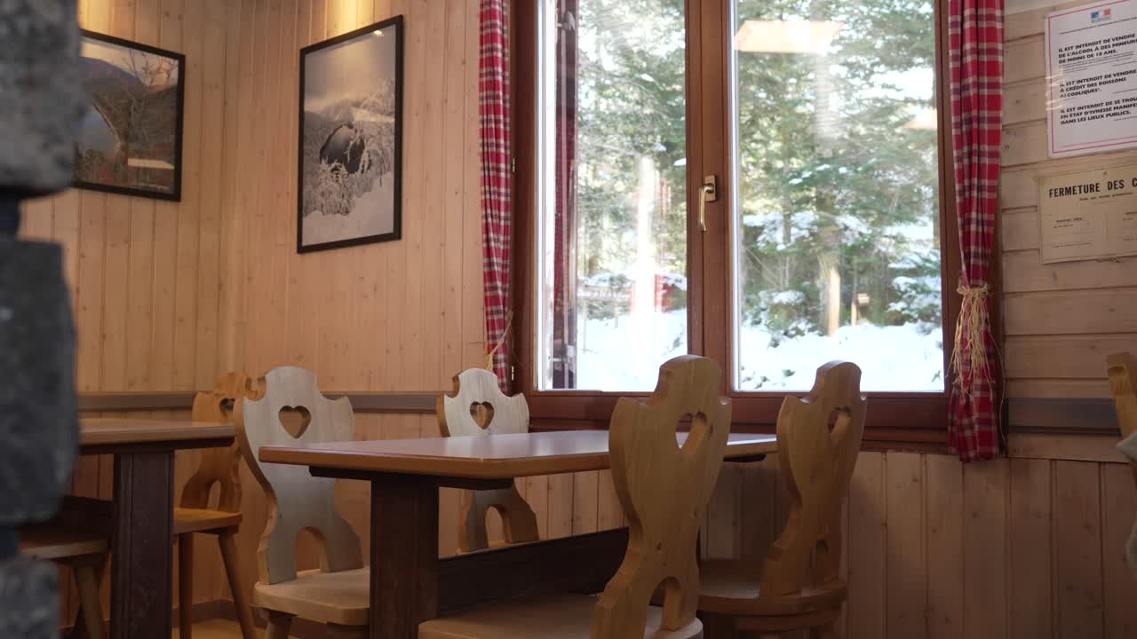 Cozy atmosphere log cabin restaurant winter weather snow window view rural bar