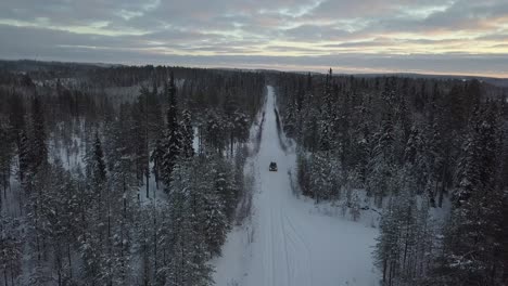 cars driving through a snow covered landscape near kuusamo, finland