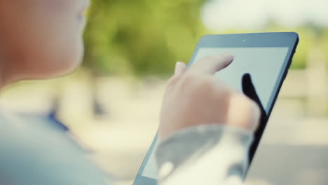 woman using digital tablet computer ipad outdoors in nature