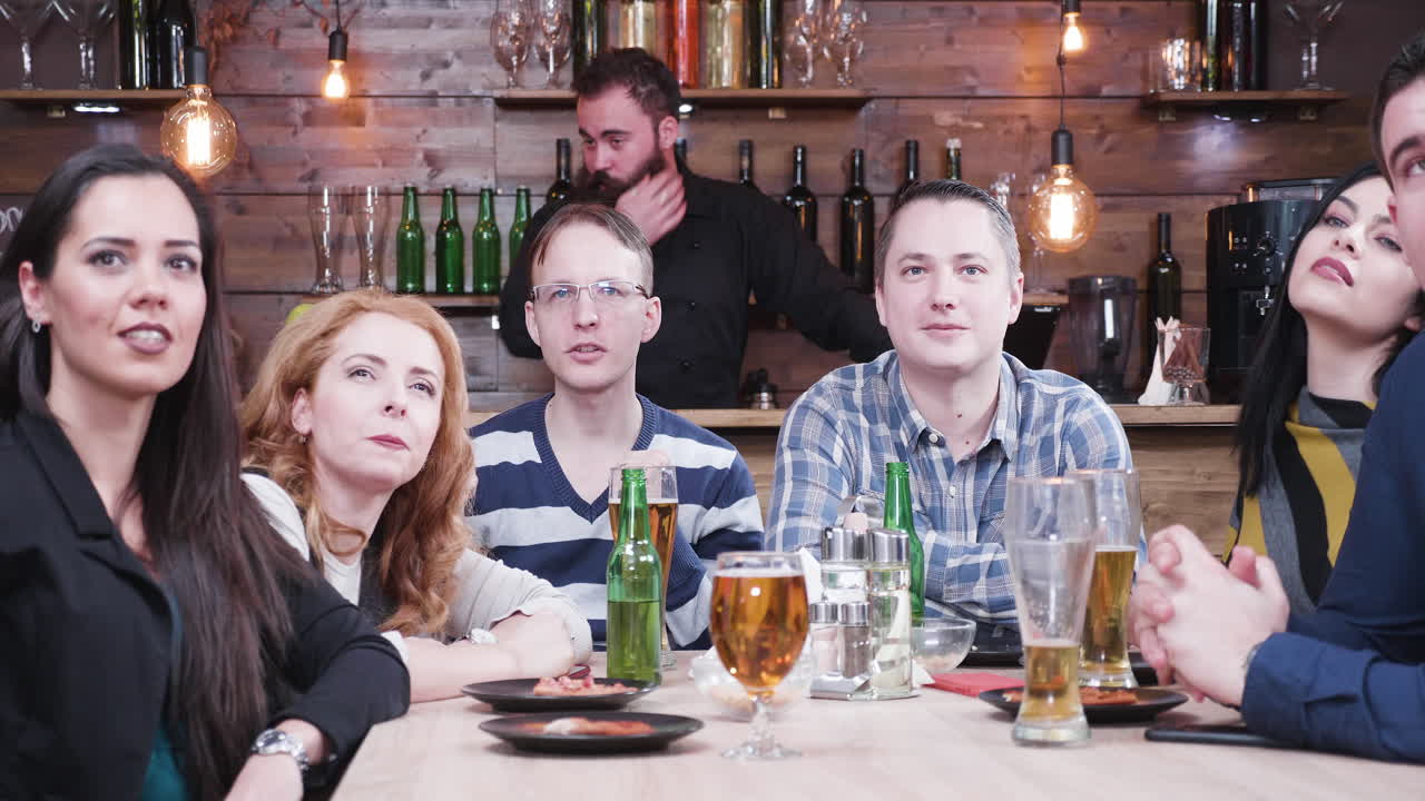 Excited Group Celebrating at a Bar