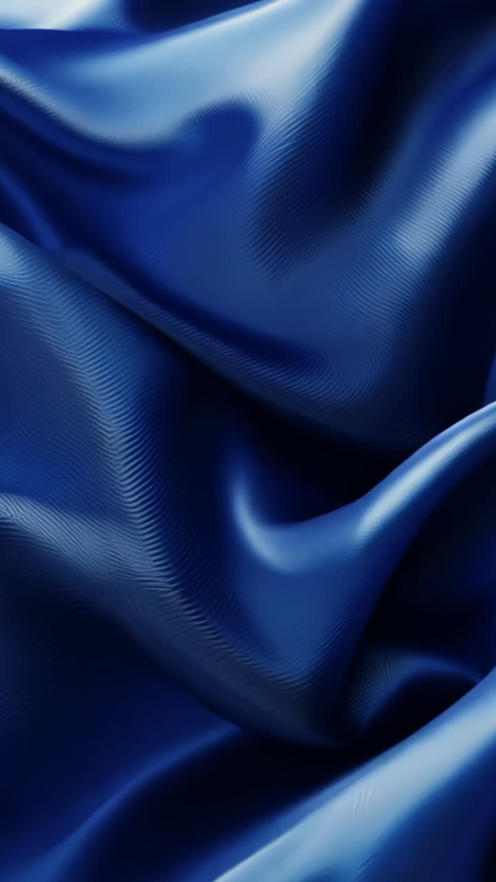 A blue fabric with a wave pattern. The fabric is flowing and has a sense of movement