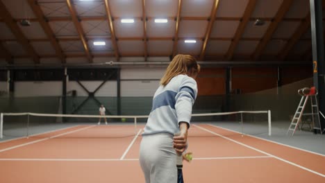 woman playing tennis indoor