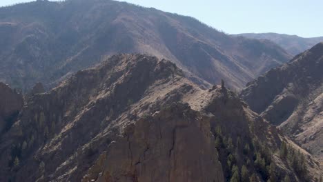 Orbiting-aerial-shot-of-a-mountain-peak-surrounded-by-other-Rocky-Mountain-peaks-in-Colorado