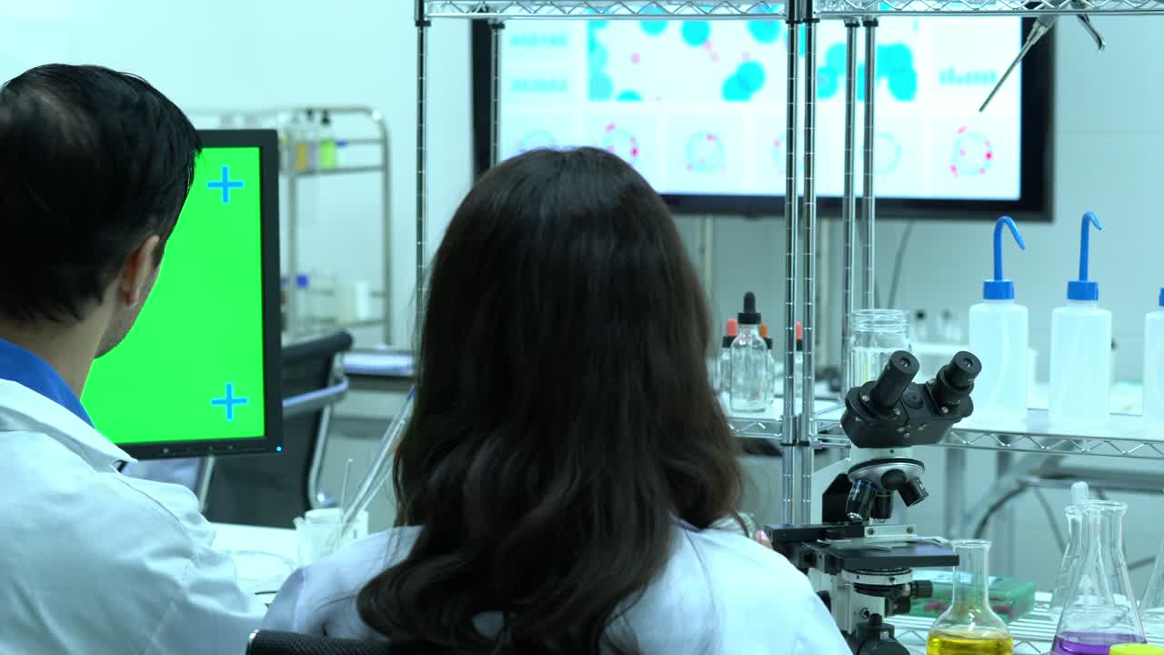 Scientist working in modern laboratory or medical center. Background monitor green screen. Concept of science, testing development and lab industry.