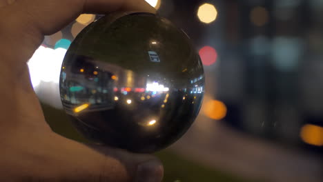 looking at night city through glass ball