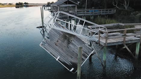 sun flaring drone orbit of broken dock after hurricane ian in the inlet