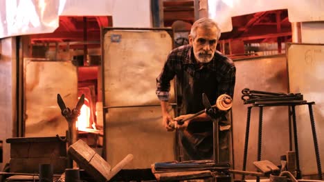 glassblower shaping a molten glass