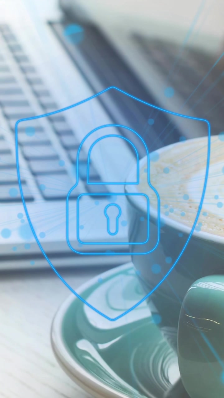 Animation of security padlock icon against mid section of woman using laptop at a cafe