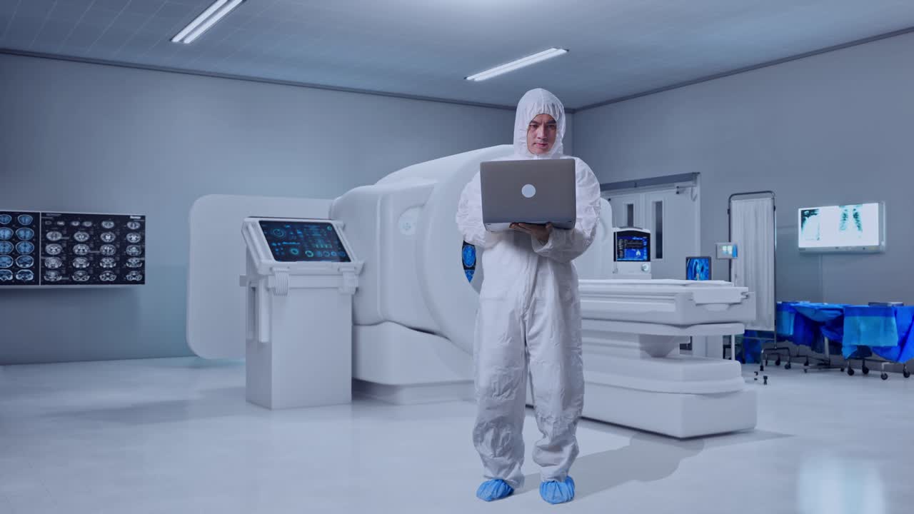 Full Body Of Asian Male Scientist Typing On A Laptop With MRI Machine In The Hospital