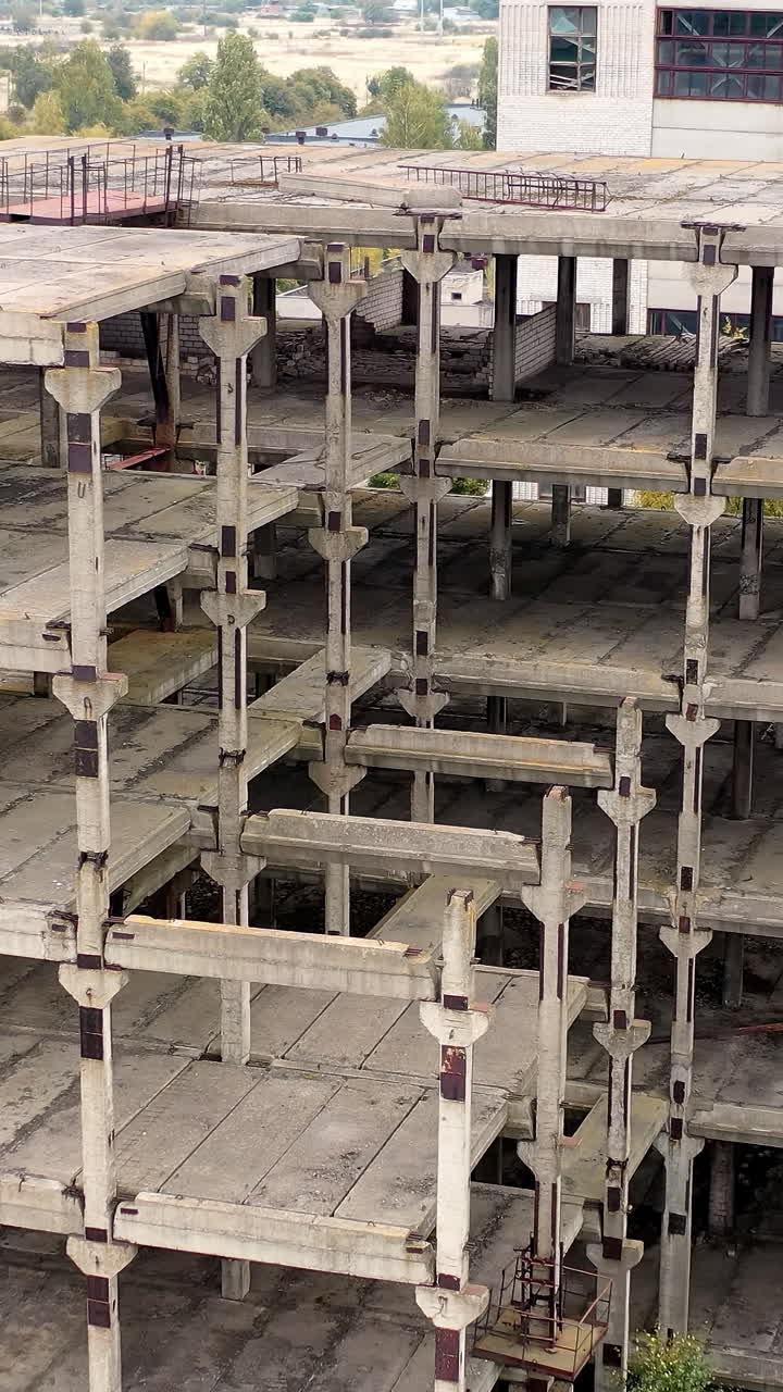 Industrial destroyed city buildings. Aerial view of destructive abandoned architecture. Vertical video