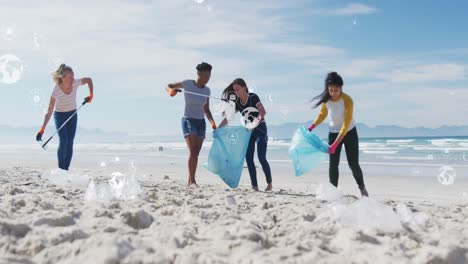 animation of globe icons over diverse female and male volunteers picking up rubbish on beach