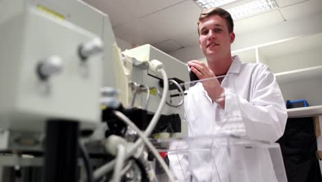 Young-science-student-looking-through-high-powered-microscope