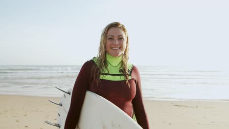 female surfer smiling at camera