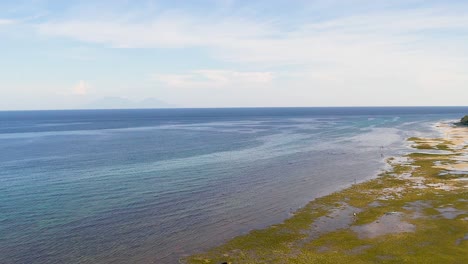 Aerial-flight-above-crystal-clear,-turquoise---green-coastal-reef-waters-in-Bohol,-Philippines