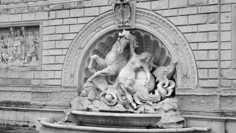 Black-and-white-shot-of-beautiful-sculpture-statue-along-the-fountain-on-stairs-leading-to-the-montagnola-park-in-Bologna,-Italy-at-daytime