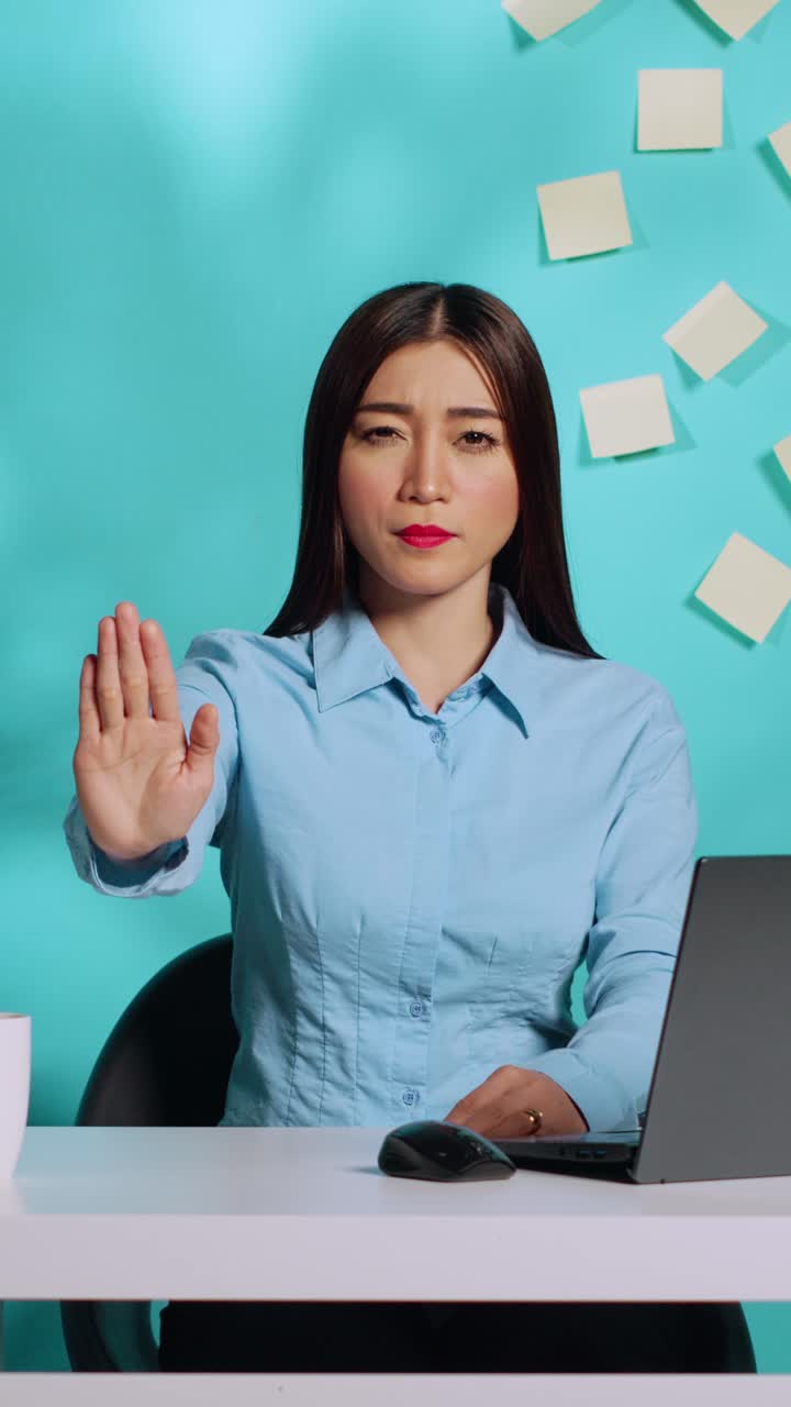 Businesswoman showing stop sign gesture