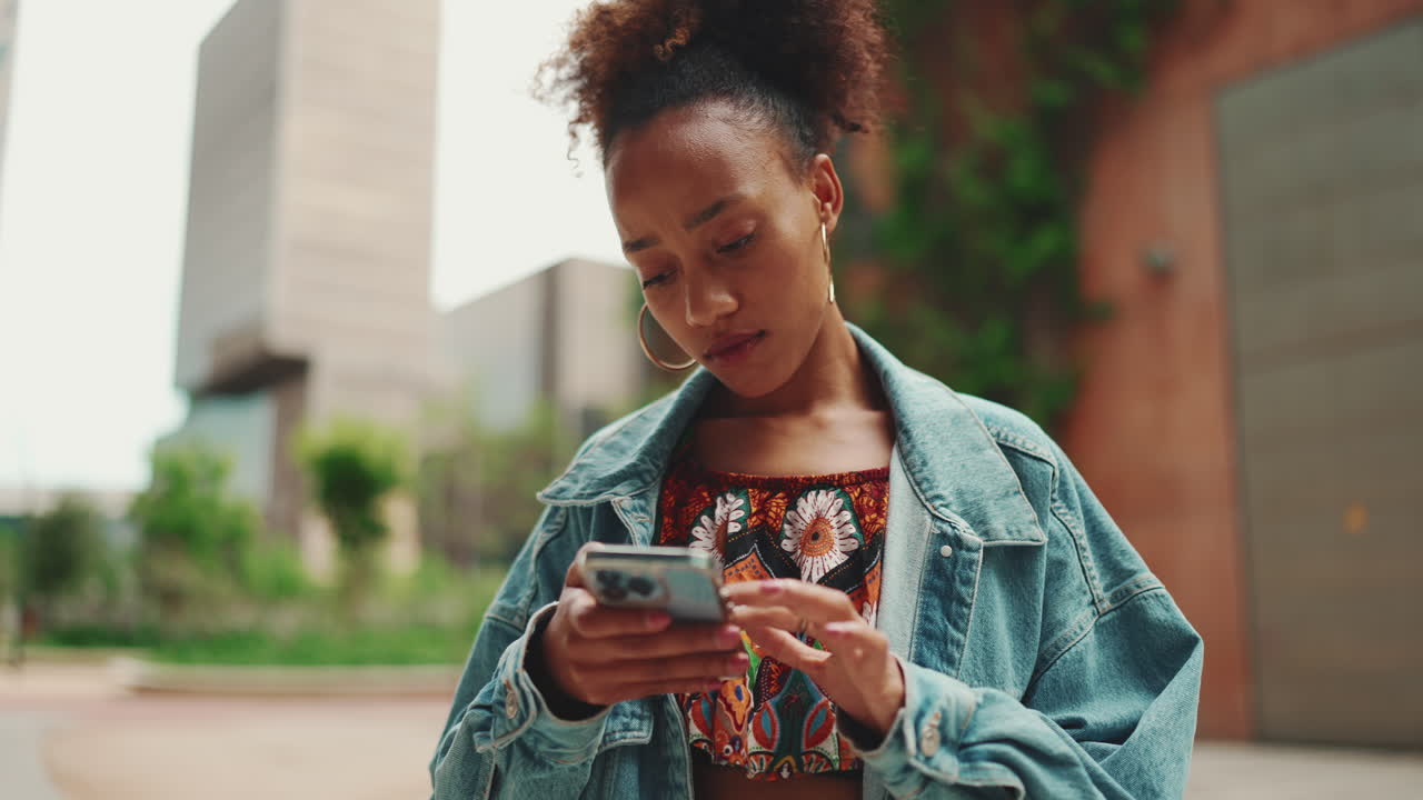 Young Woman Using Mobile Phone in Urban Setting