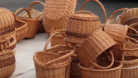 wicker baskets piled on a table in the street