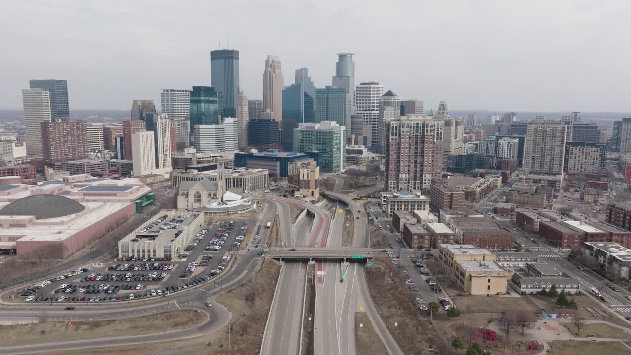Aerial of downtown Minneapolis with highway and city skyline in view.