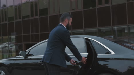 business lady getting out of black car