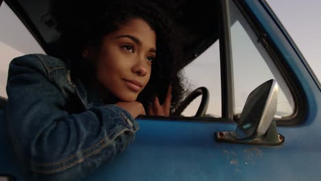 Woman-leaning-on-window-of-pickup-truck-at-beach-4k