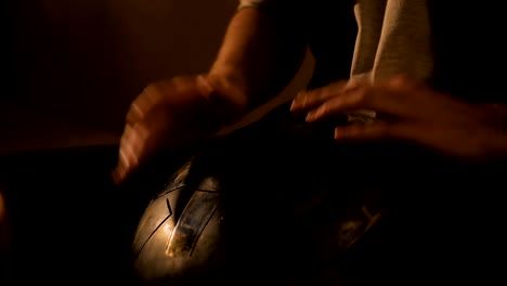 man playing hang drum